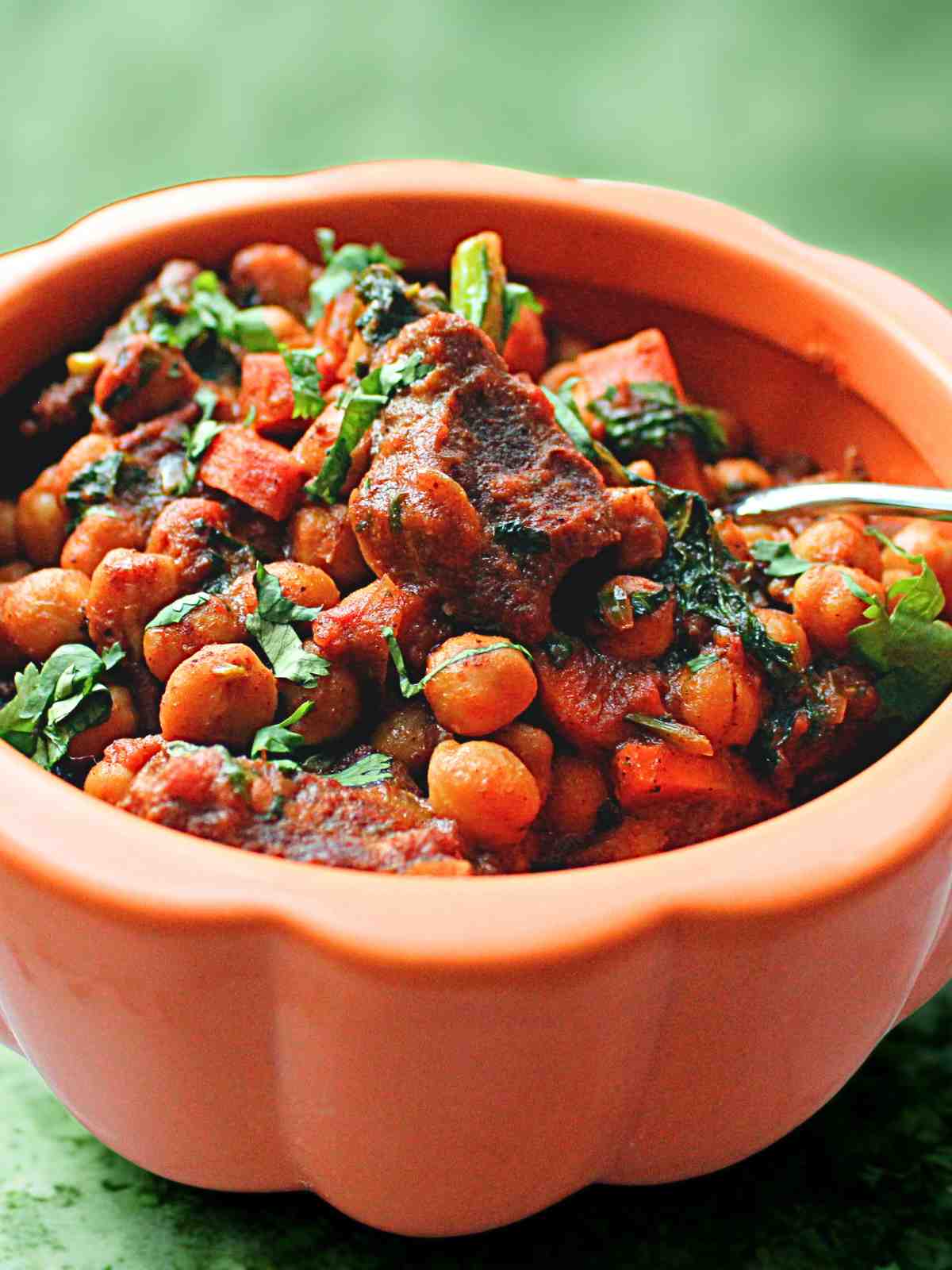 Showing texture of tender goat meat in a serving bowl.