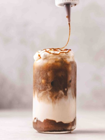 iced pumpkin spic latte with pumpkin spice syrup drizzled over it.