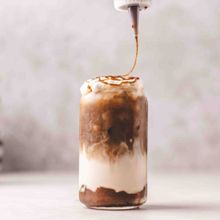 iced pumpkin spic latte with pumpkin spice syrup drizzled over it.
