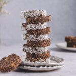 a photo of stacked cornflake cakes garnished with coconut shreds