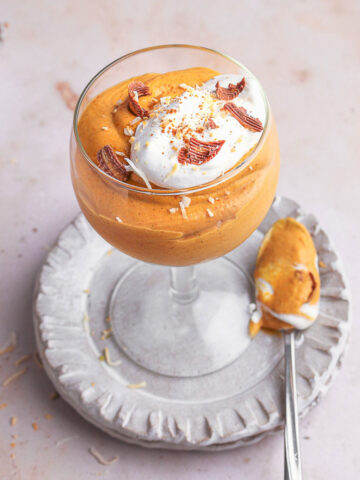 Coconut cream pumpkin mousse in a serving glass with spoon