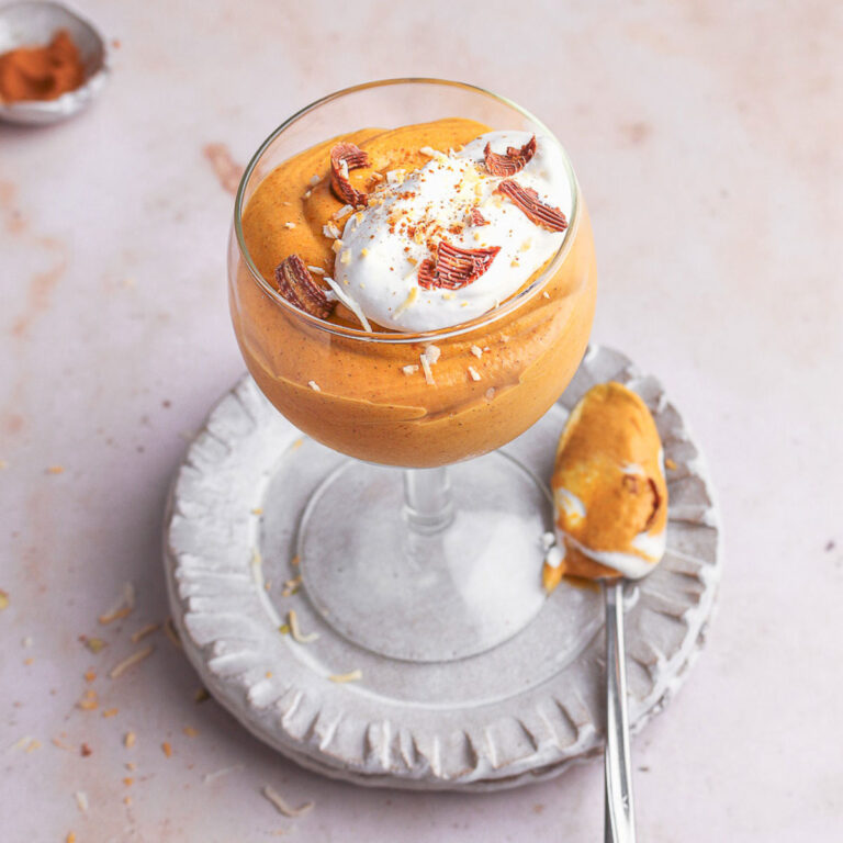 Coconut cream pumpkin mousse in a serving glass with spoon