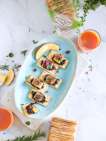A tray of croccantini with bacon jam, cheese and prosciutto