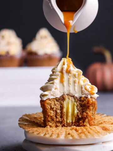 Pouring caramel syrup over hazelnut cupcake