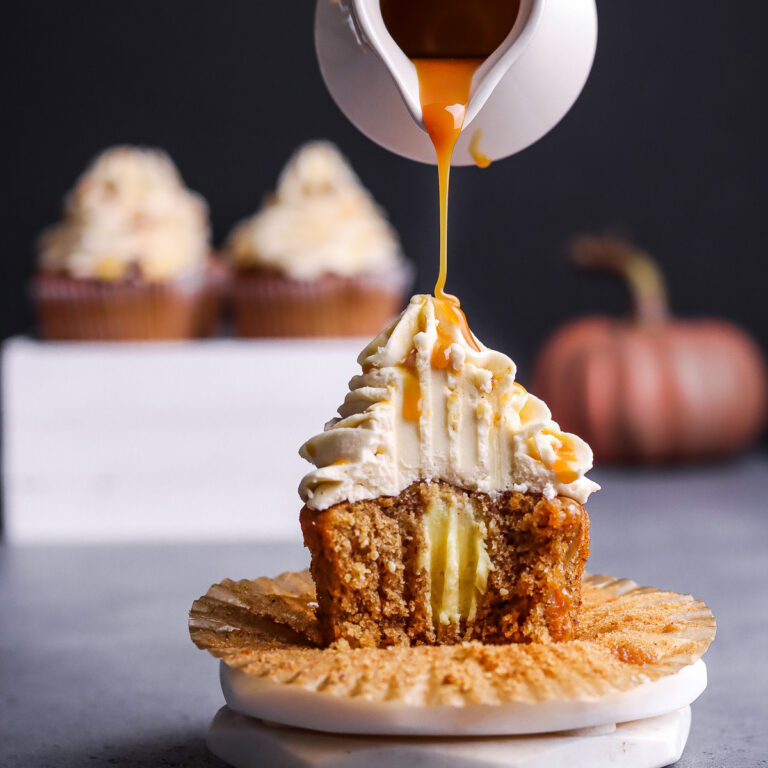 Pouring caramel syrup over hazelnut cupcake