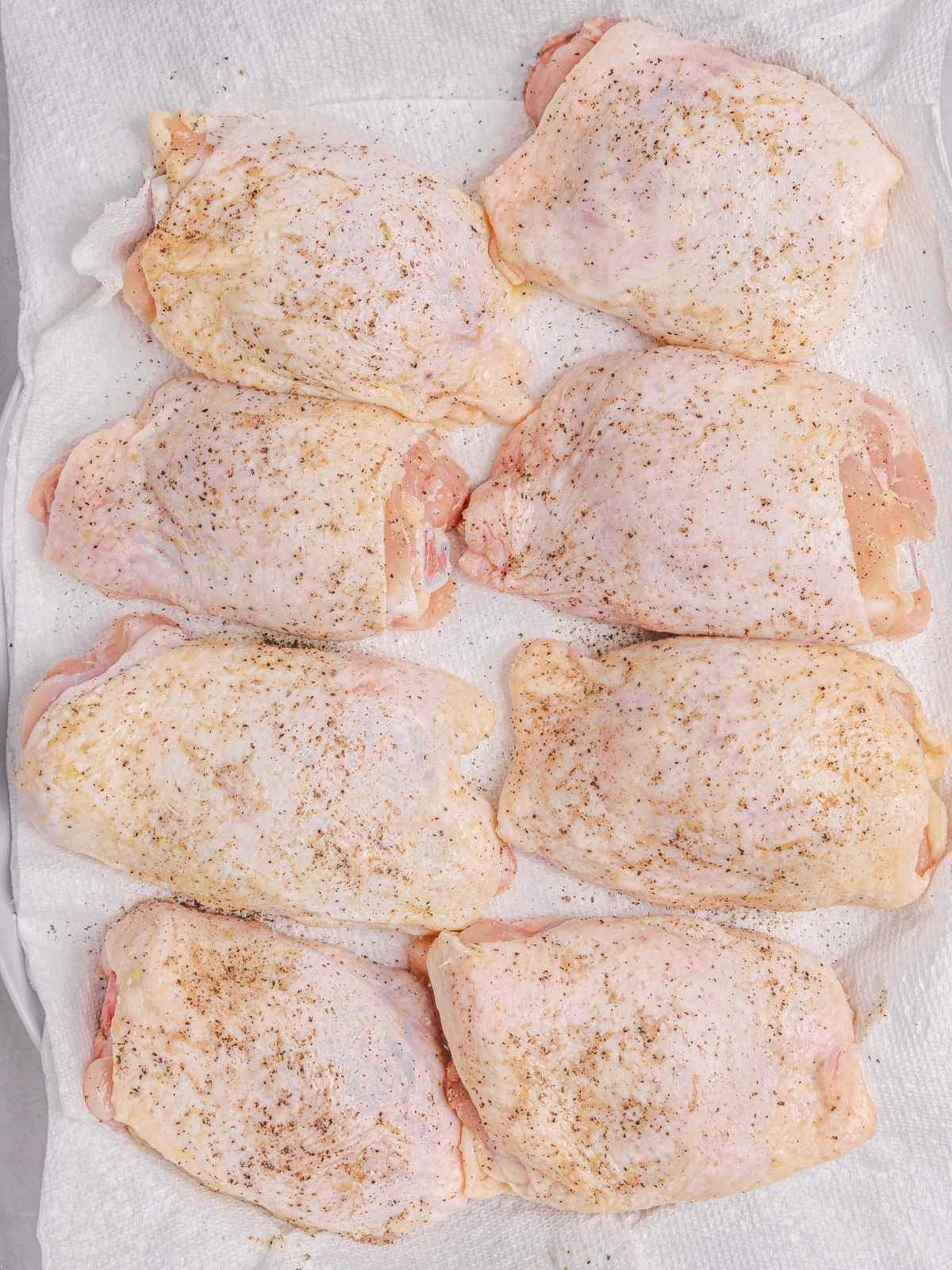Seasoning the chicken.