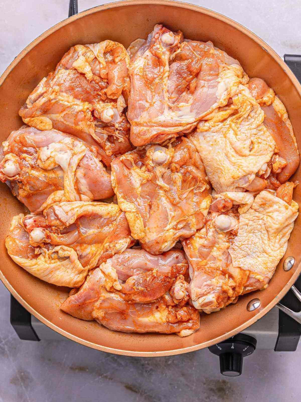 Searing the chicken on an oven-safe pan.