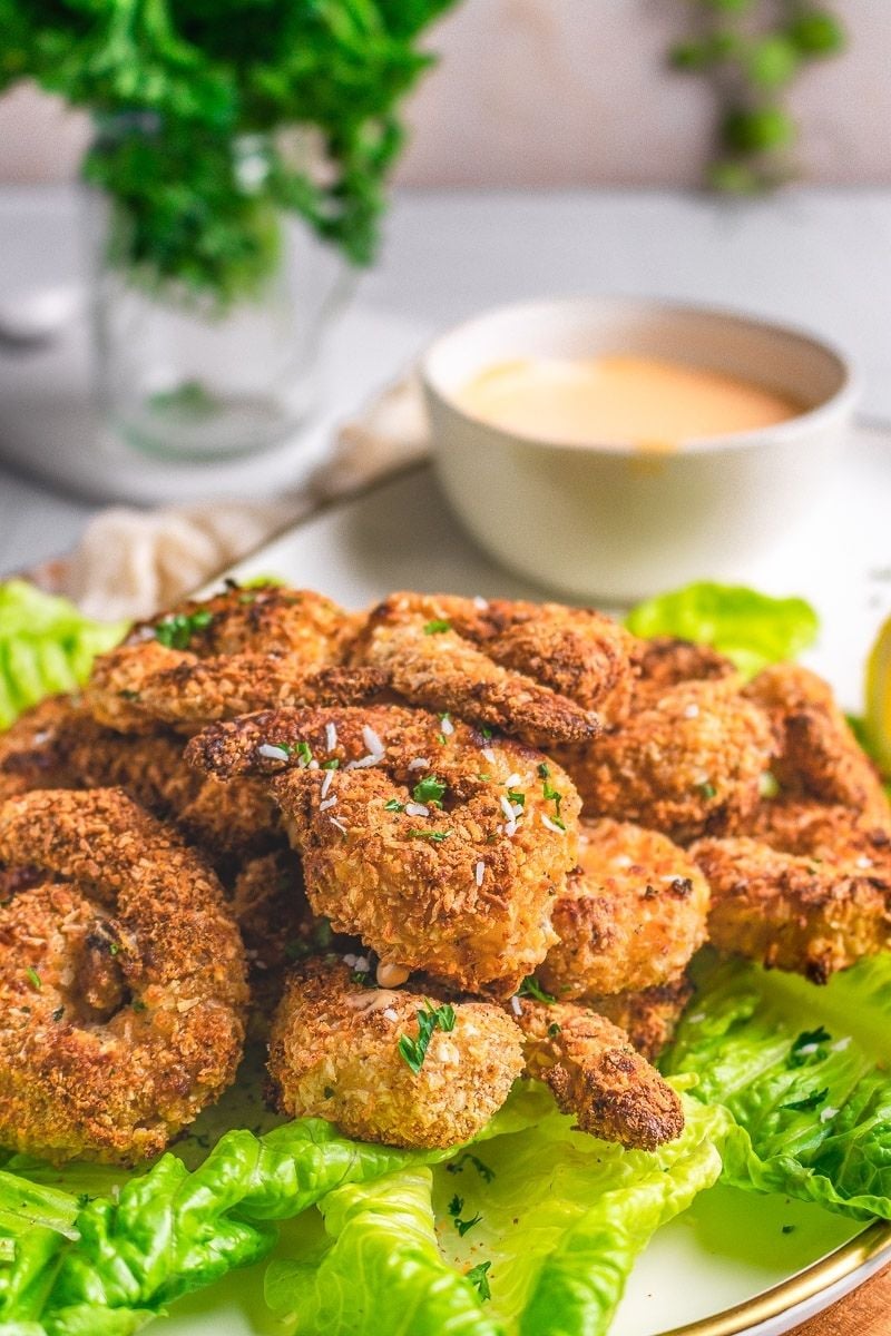 a close up of jumbo breaded shrimp on a platter