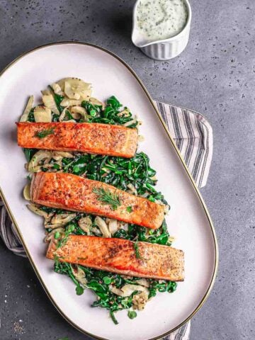 seared salmon served with greens