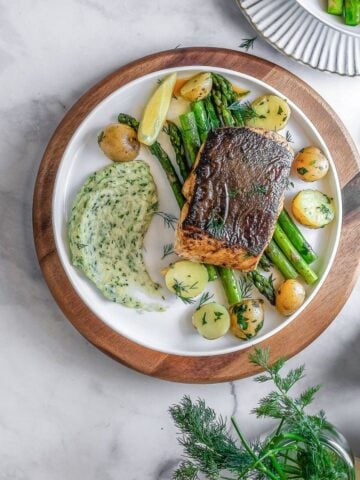 halibut steak on a plate with veggies