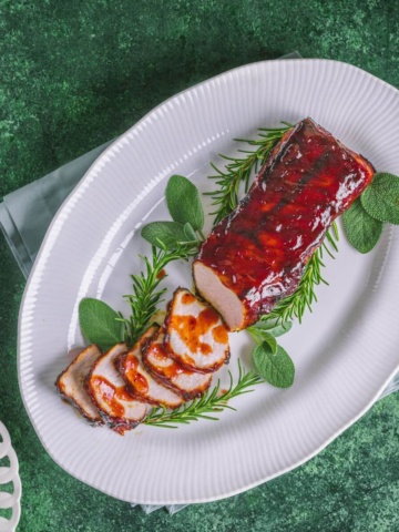 Air Fryer Pork Tenderloin with Cranberry bbq Sauce on a plate
