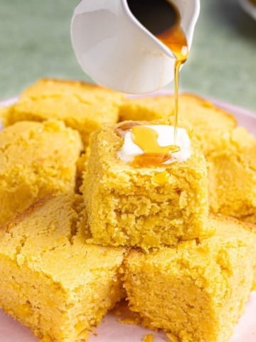 cornbread without eggs stacked on a plate.