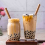 Brown sugar bubble tea in a cup with straws.