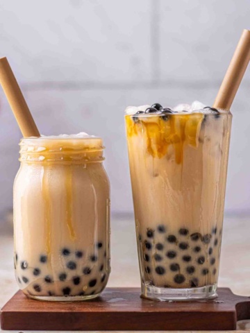 Brown sugar bubble tea in a cup with straws.