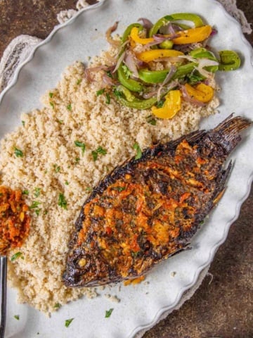 Attieke or acheke cassava couscous with air fried fish and pepper sauce.