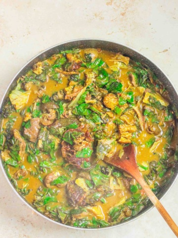 oha pot of soup with a serving spoon.