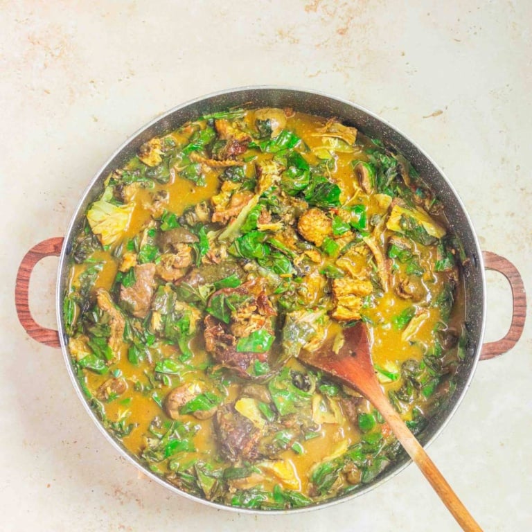 oha pot of soup with a serving spoon.