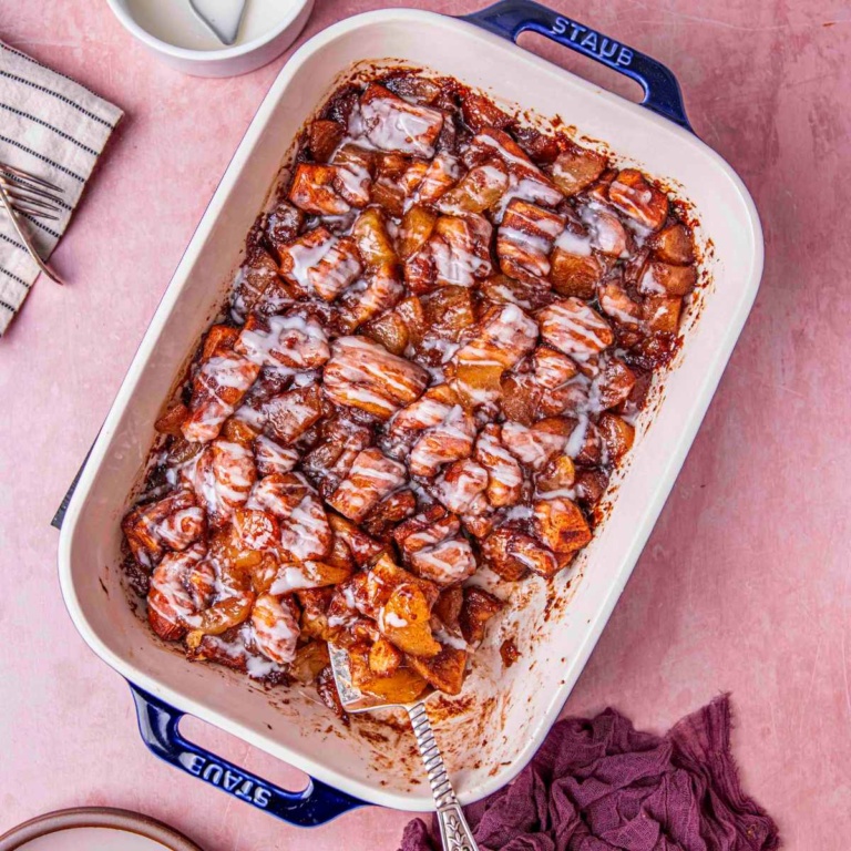 cinnamon roll with apple pie drizzled with creamy glaze.