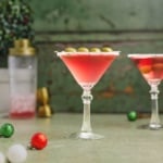 Christmas martini with salt frosted rim on a flat surface.