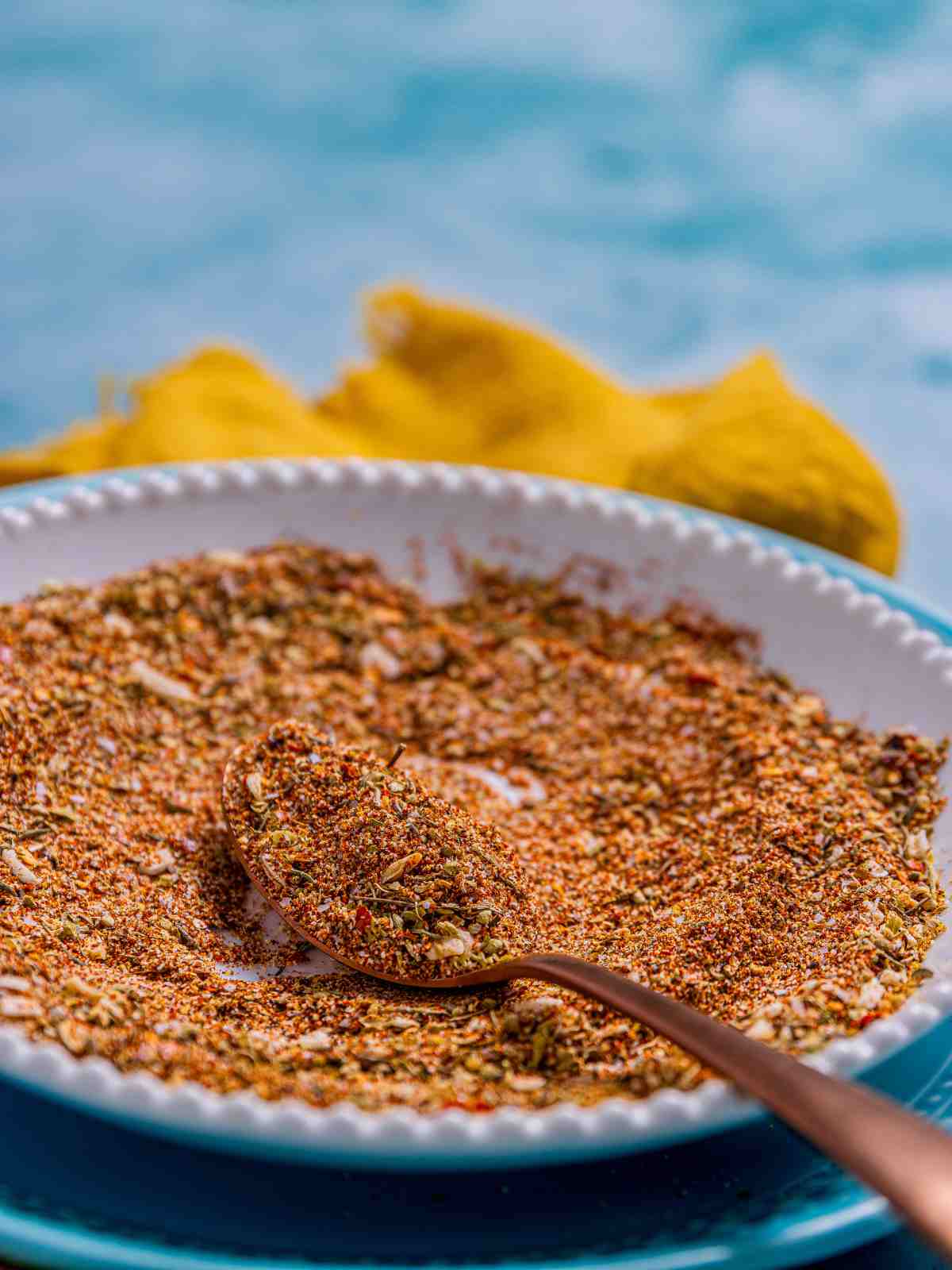Taco seasoning mix in a dish plate with spoon.