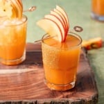 bourbon apple cider cocktail in a glass rimmed with cinnamon sugar.