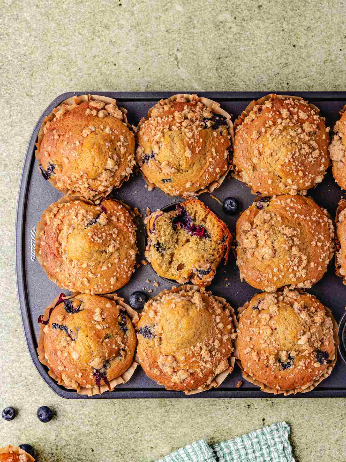 Cottage cheese muffins in  muffin tins on a flat surface.