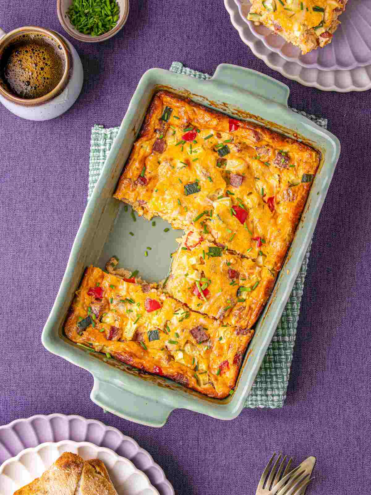 Cottage cheese egg bake in a dish with ciabatta bread on the side.