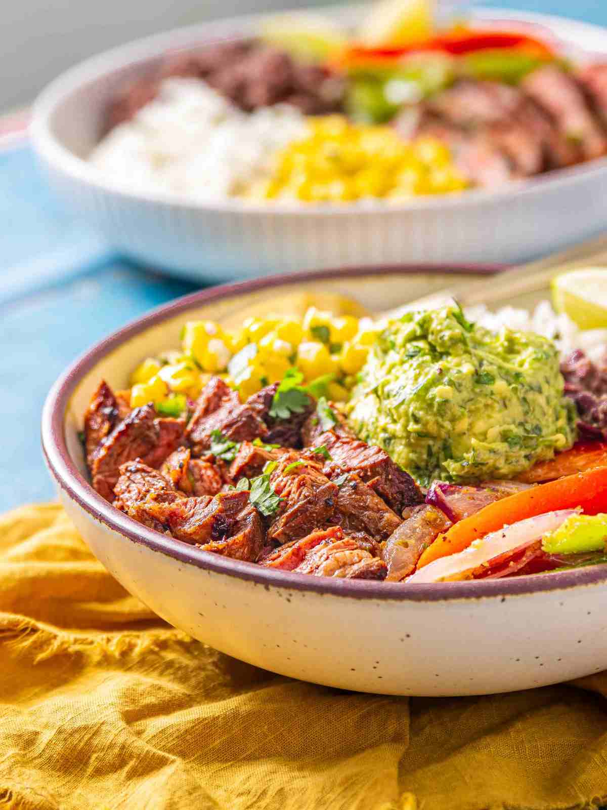 Steak bites with grilled veggies in a bowl.