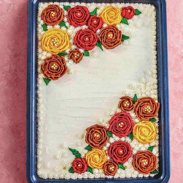 apple pumpkin sheet cake with maple frosting on a flat surface.