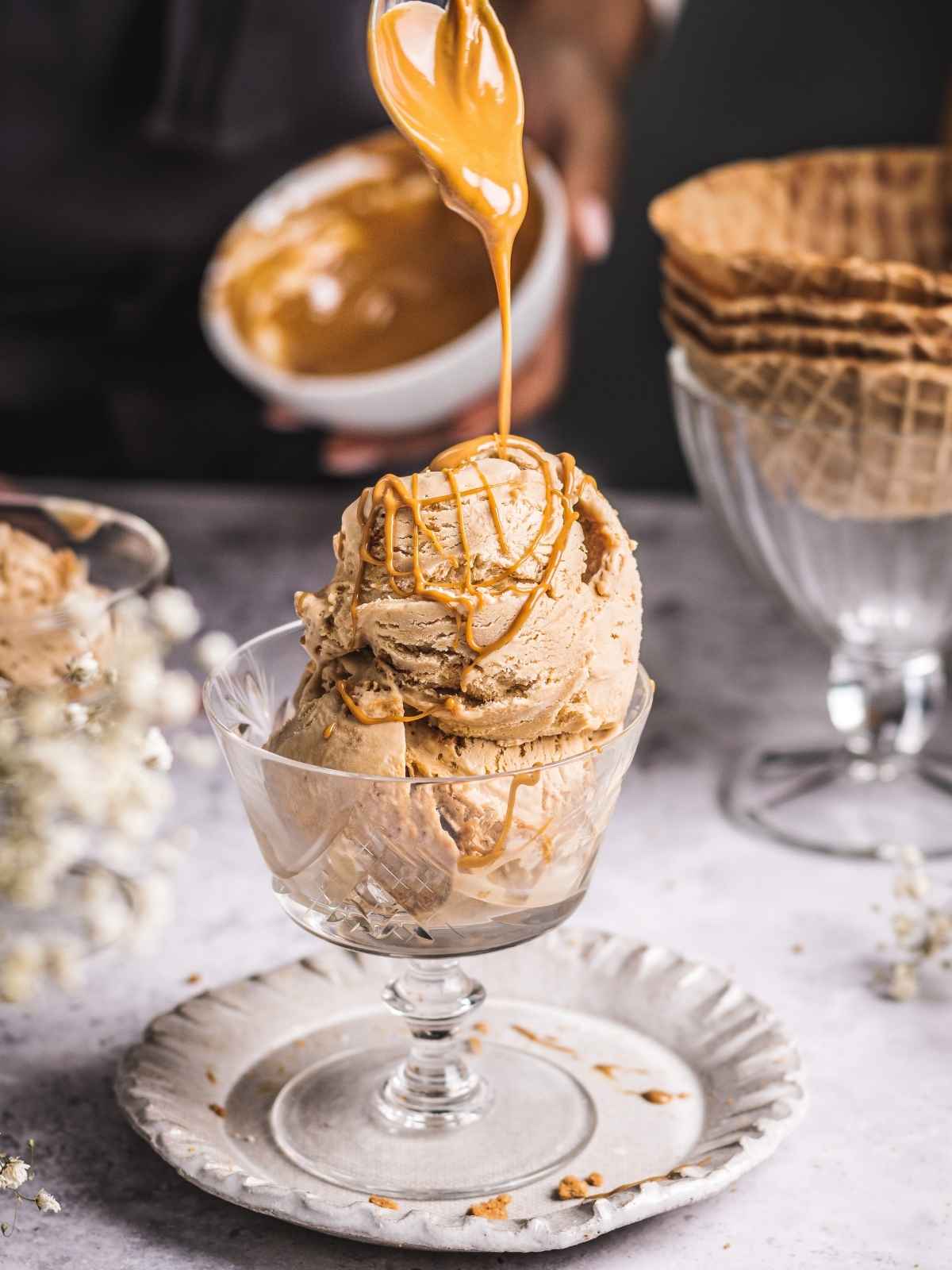 Drizzling scoops of ice cream with biscoff butter.