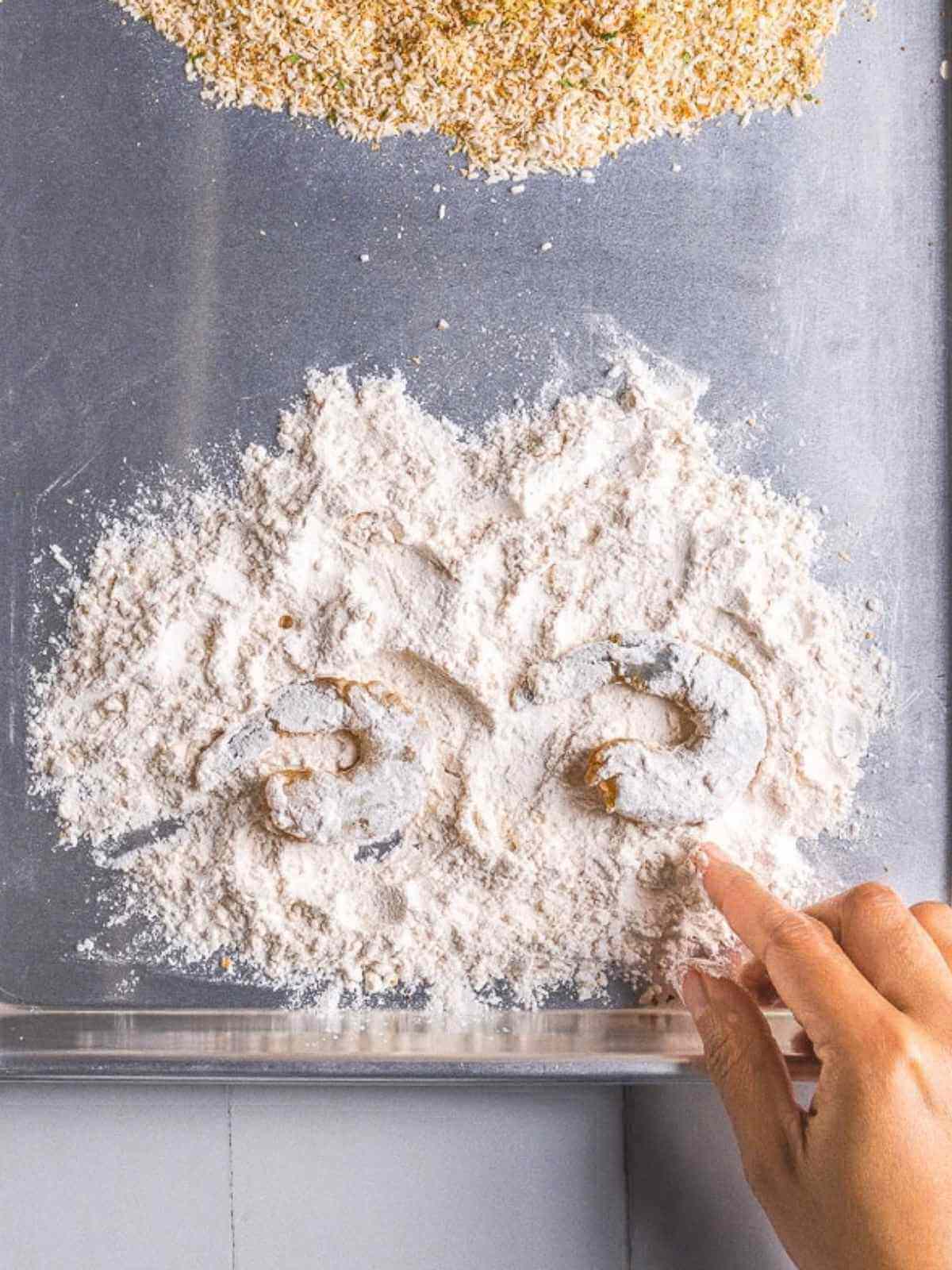 Tossing in the shrimp in the flour
