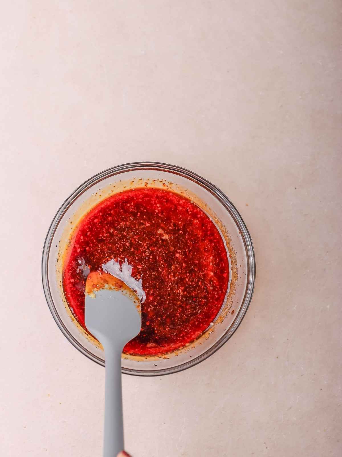 Mixing the sauce in a small bowl.