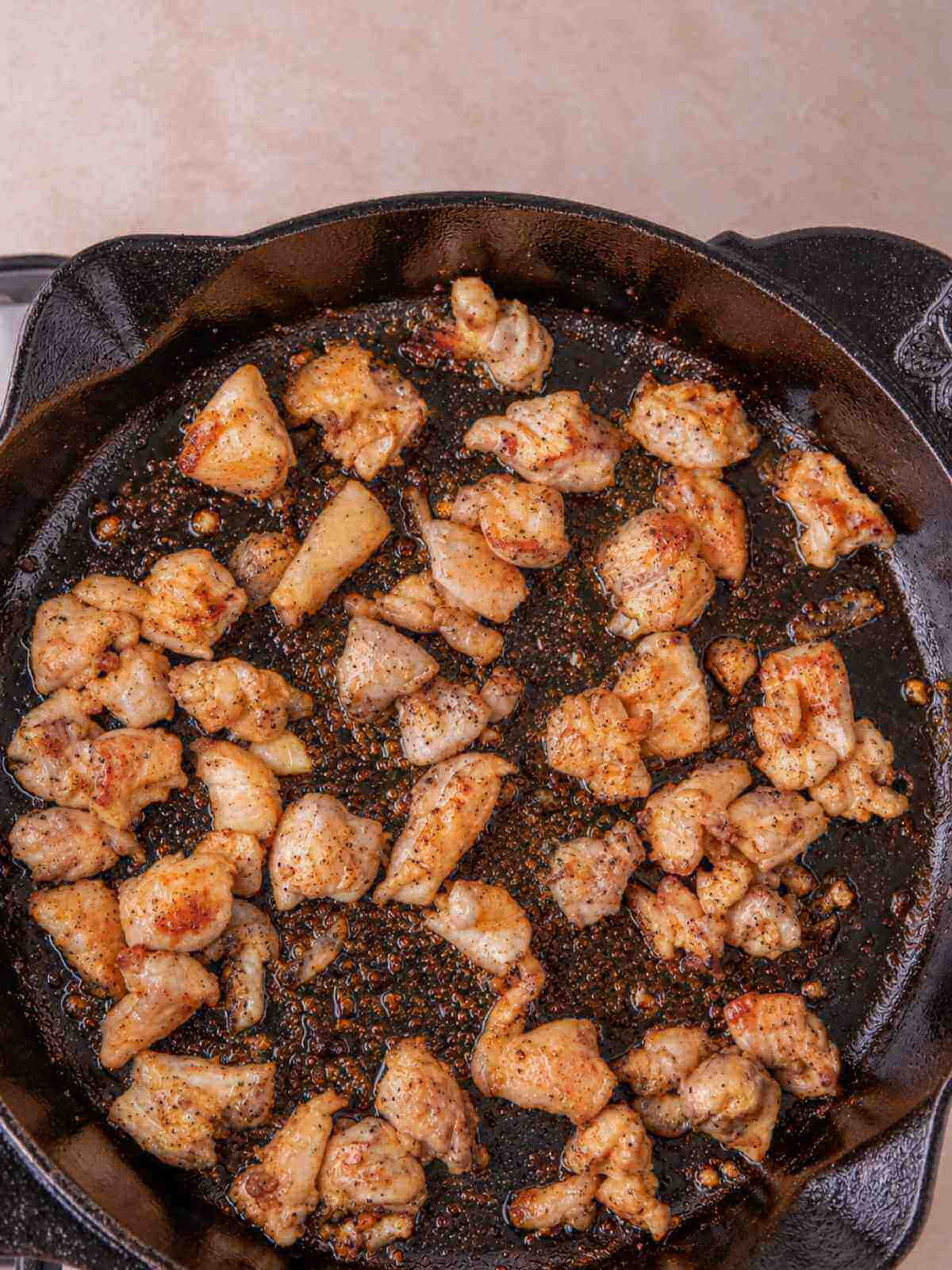 Cooking the chicken in a heavy bottom pot with olive oil.