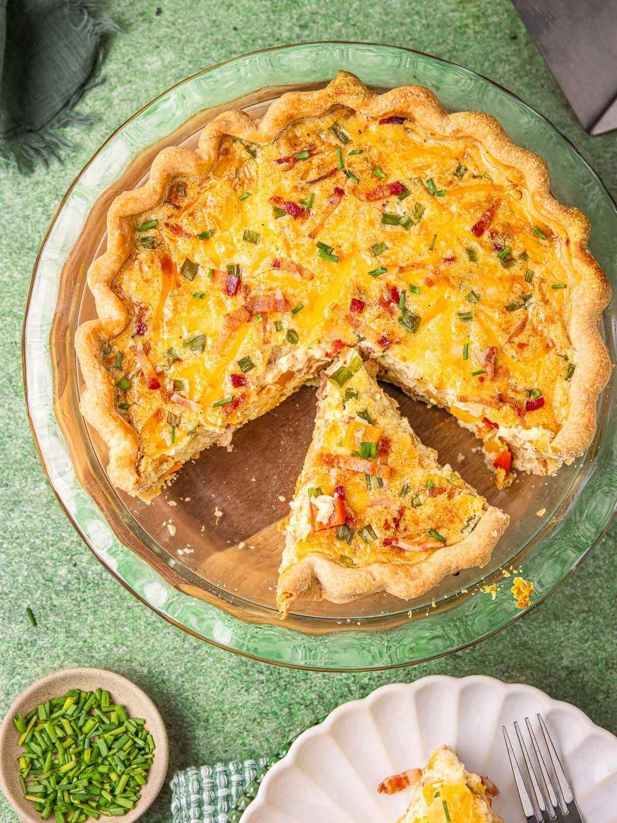 Bacon quiche sliced on a serving platter.