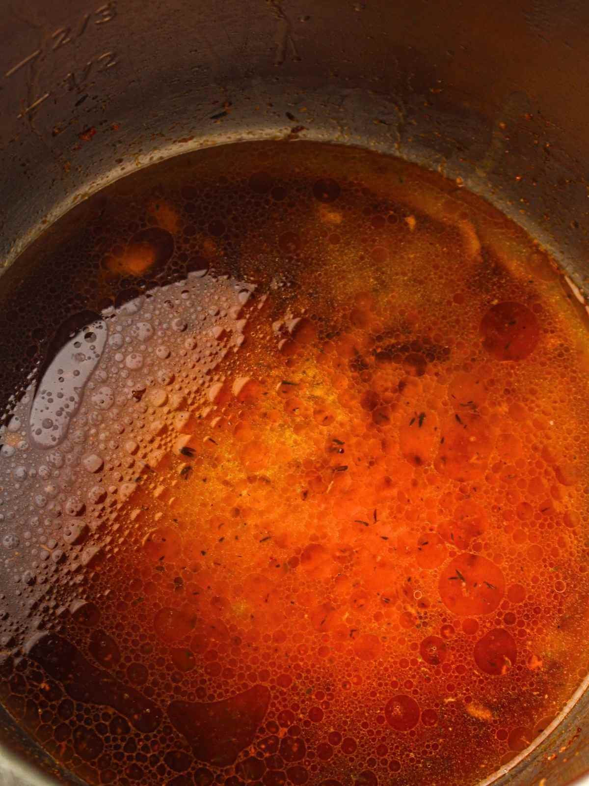 Scrapping the bottom of the pan before adding the chicken stock.